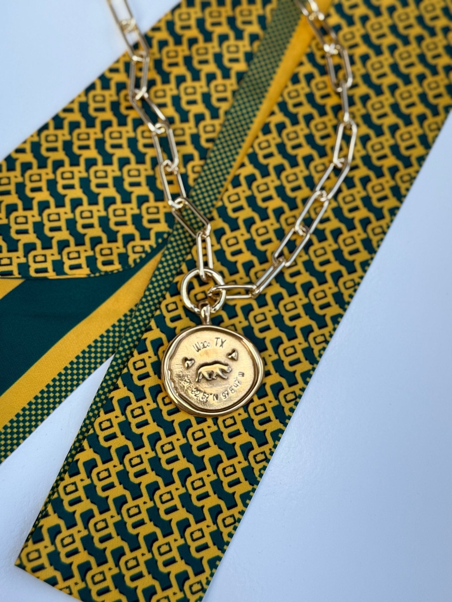 Waco Necklace with a gold medallion engraved Waco, Texas and its coordinates, alternate view