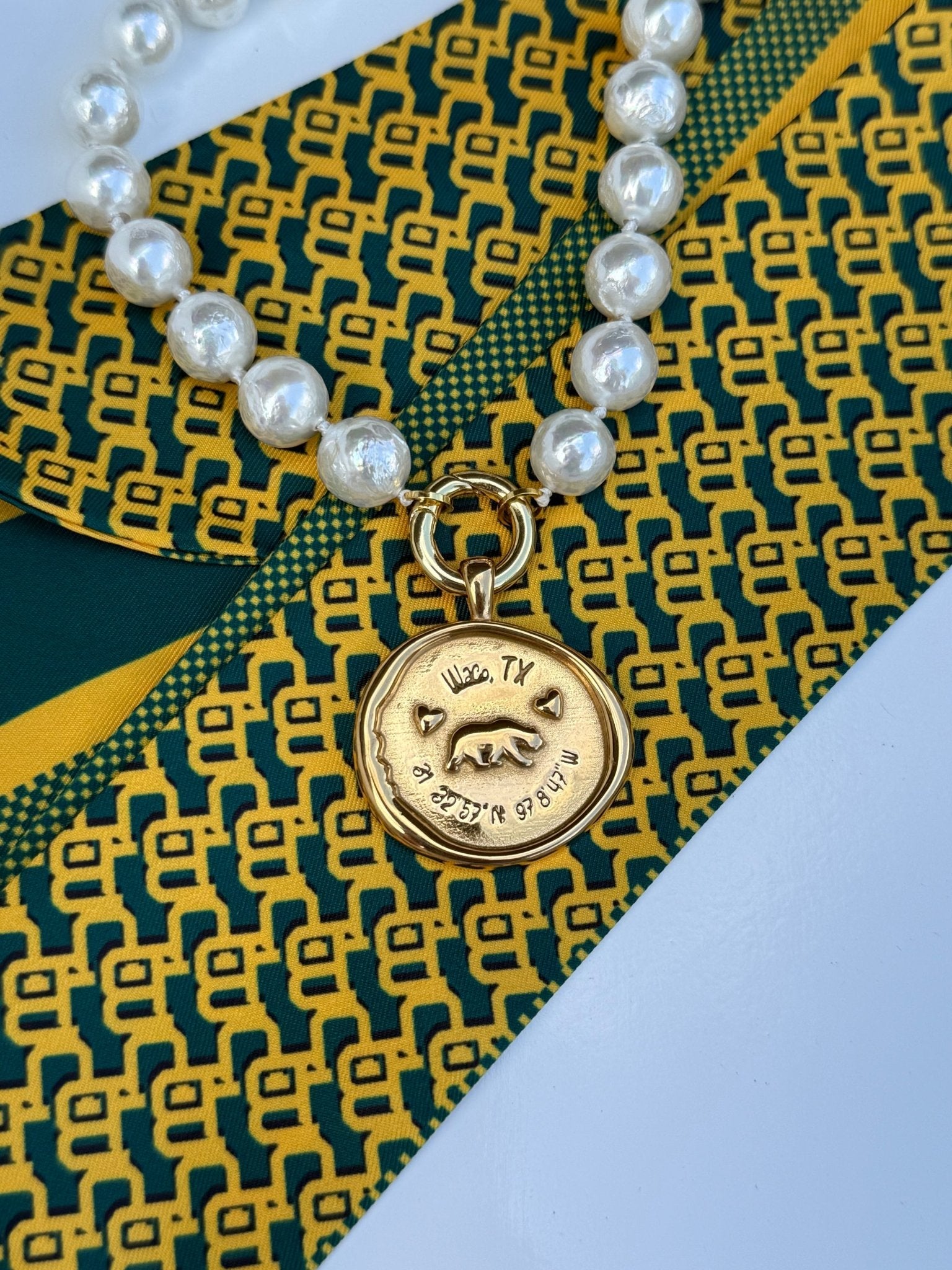 Waco Necklace with a gold medallion engraved Waco, Texas and its coordinates