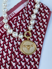 Tuscaloosa Necklace with a gold medallion engraved Tuscaloosa, Alabama and its coordinates