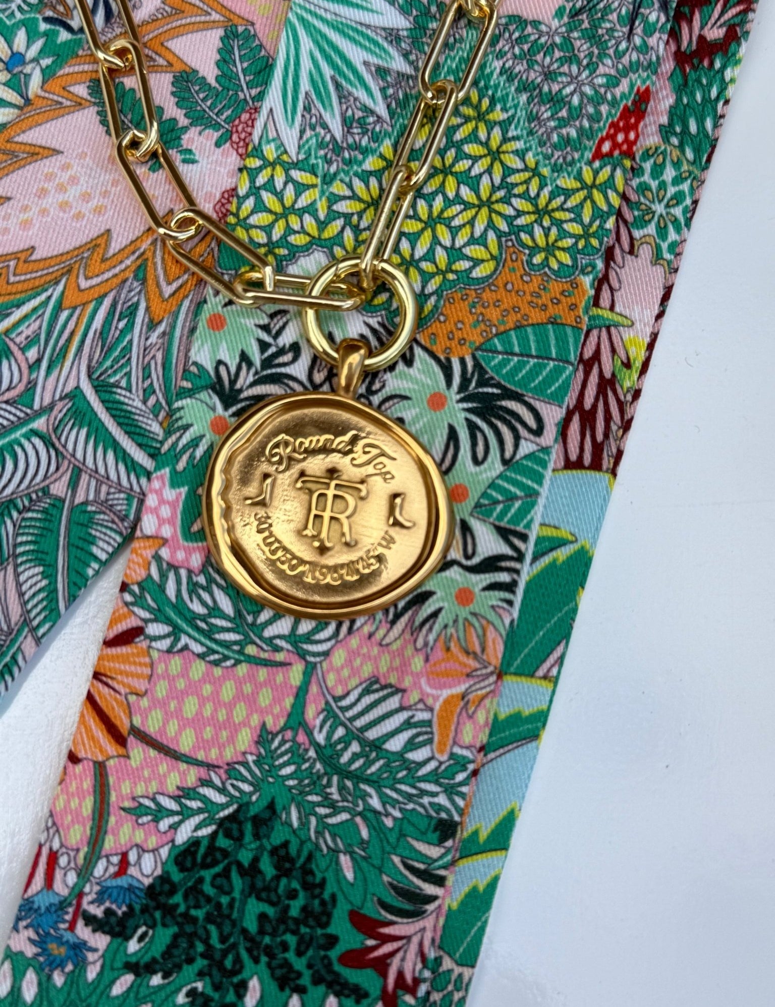 Round Top Necklace with a gold crest medallion