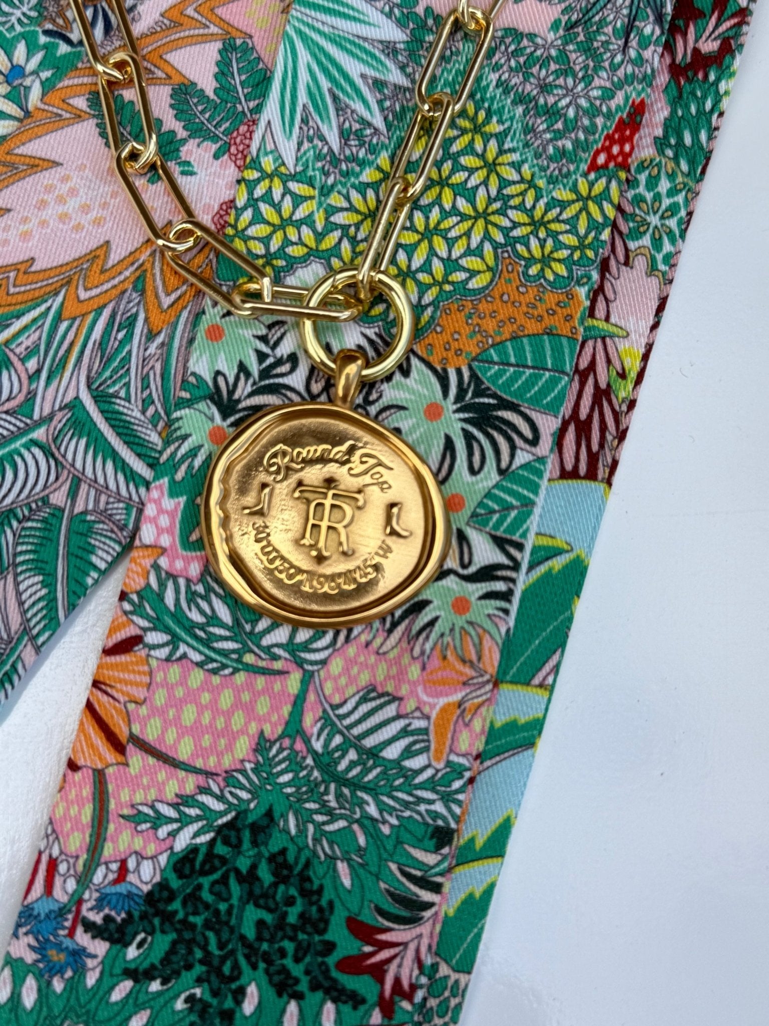 Round Top Necklace with a gold crest medallion