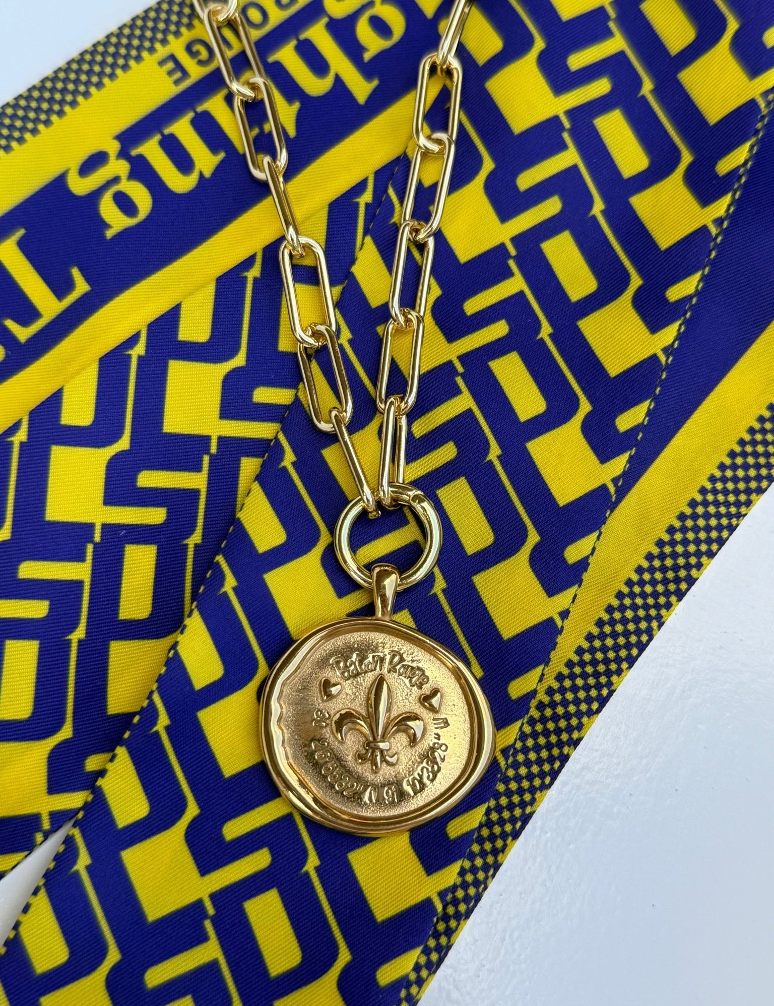 Baton Rouge Necklace with a gold fleur-de-lis medallion and Baton Rouge coordinates