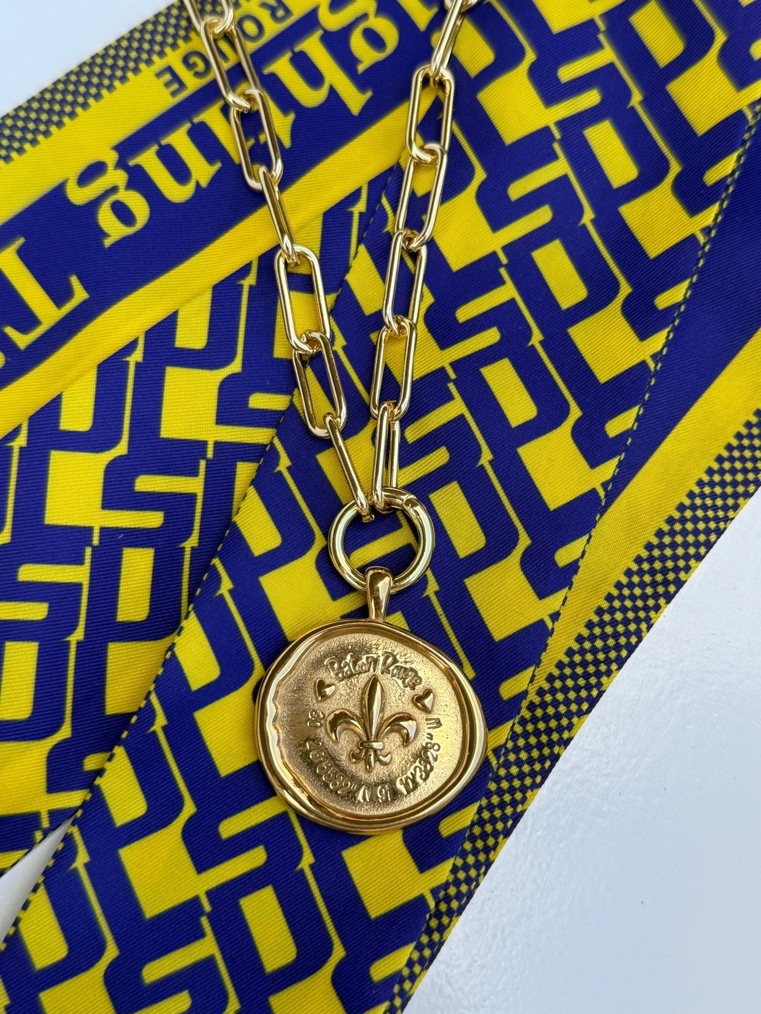 Baton Rouge Necklace with a gold fleur-de-lis medallion and Baton Rouge coordinates