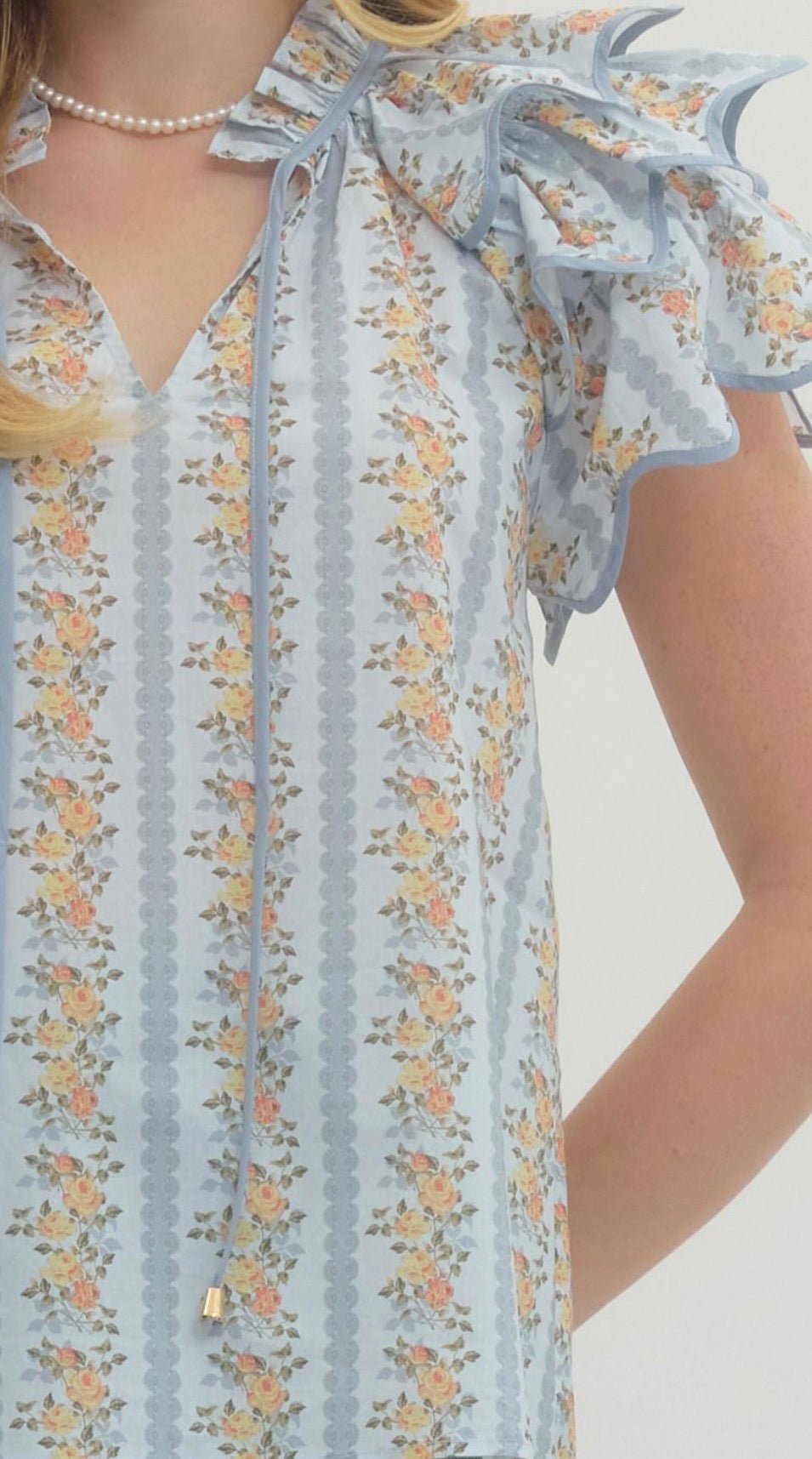 Close-up of the floral trellis detail and flared shape on the Floral Trellis Top – Lady & Tucker