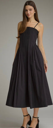 Back view of the Sawyer Dress, a black pleated square-neck midi