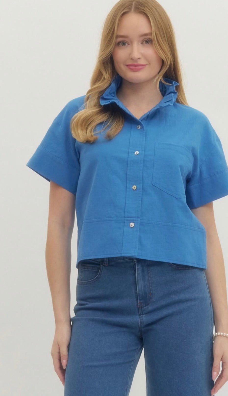 Blue Ruffle Neck Top, a blue cropped ruffle neck button-down, worn front view