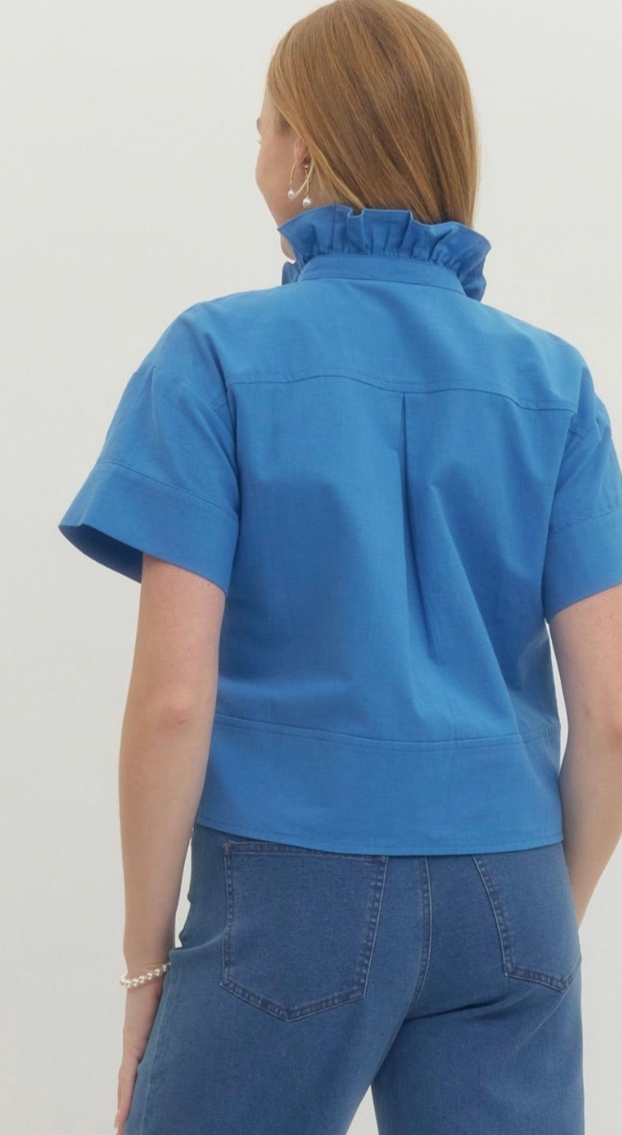 Back view of the Blue Ruffle Neck Top, a blue cropped ruffle neck button-down – Lady & Tucker