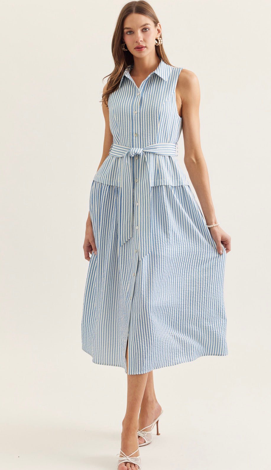 Savannah Stripe Dress, a blue and white stripe sleeveless midi shirt dress, worn front view