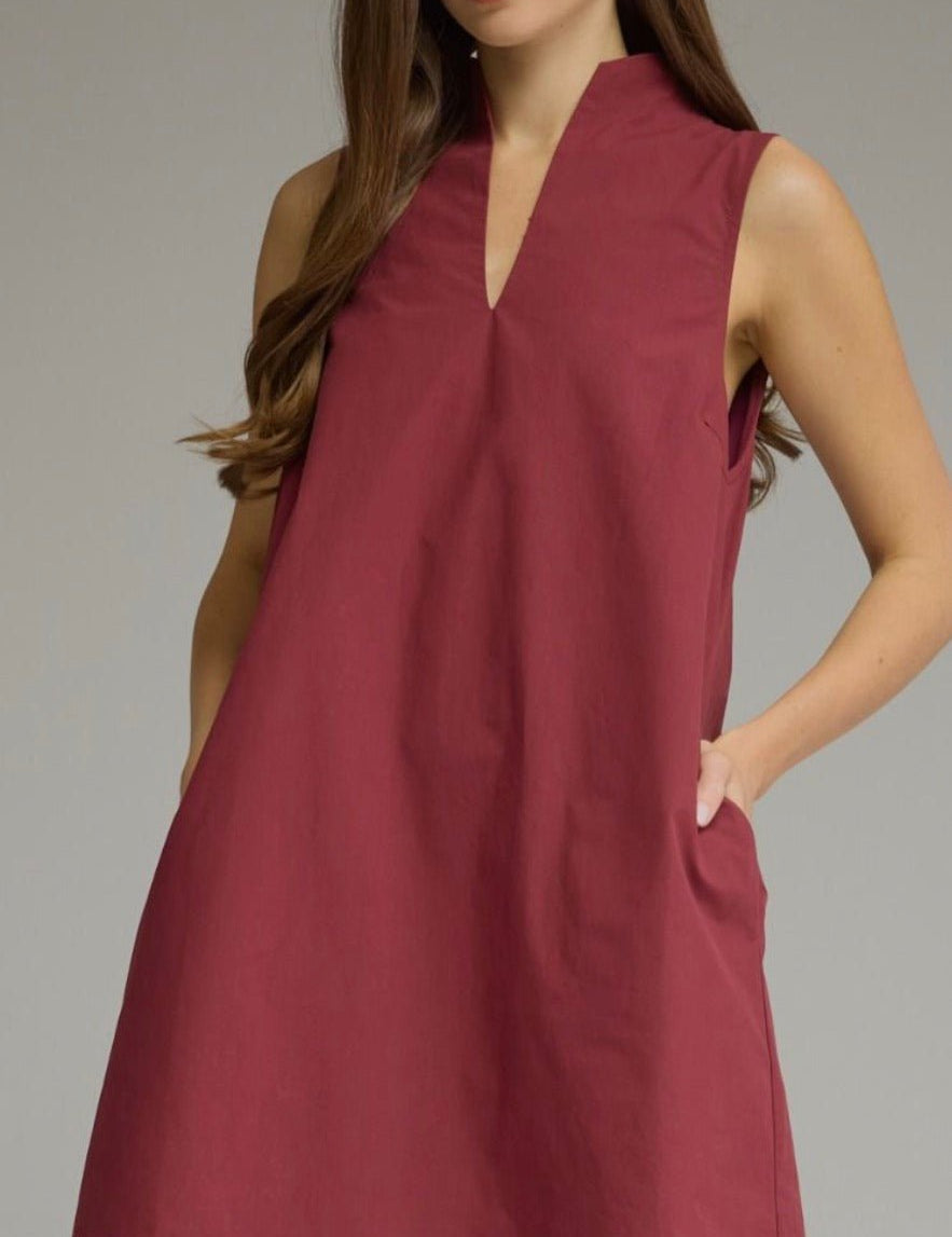 The Rev Dress, a burgundy sleeveless mini dress, worn front view
