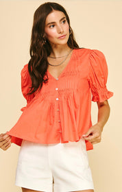 Sun Orange Top, a coral pintuck blouse, worn front view