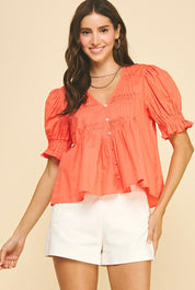 Back view of the Sun Orange Top, a coral pintuck blouse