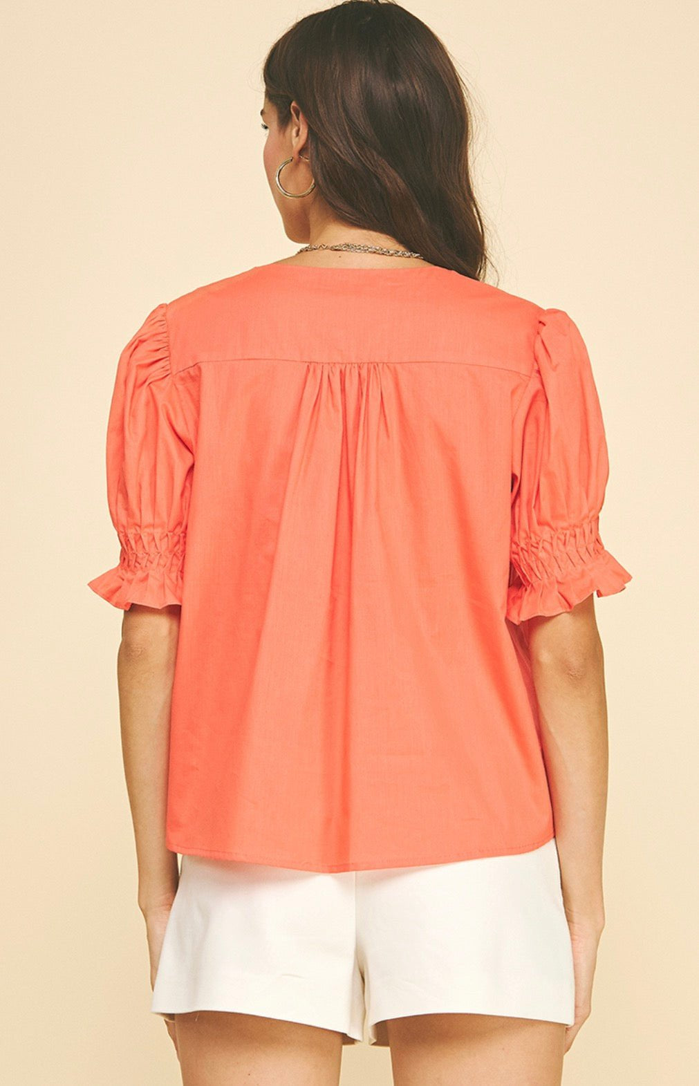Close-up of the pintuck detail on the Sun Orange Top