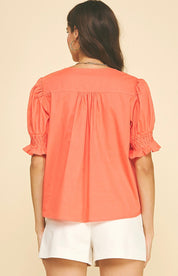 Close-up of the pintuck detail on the Sun Orange Top