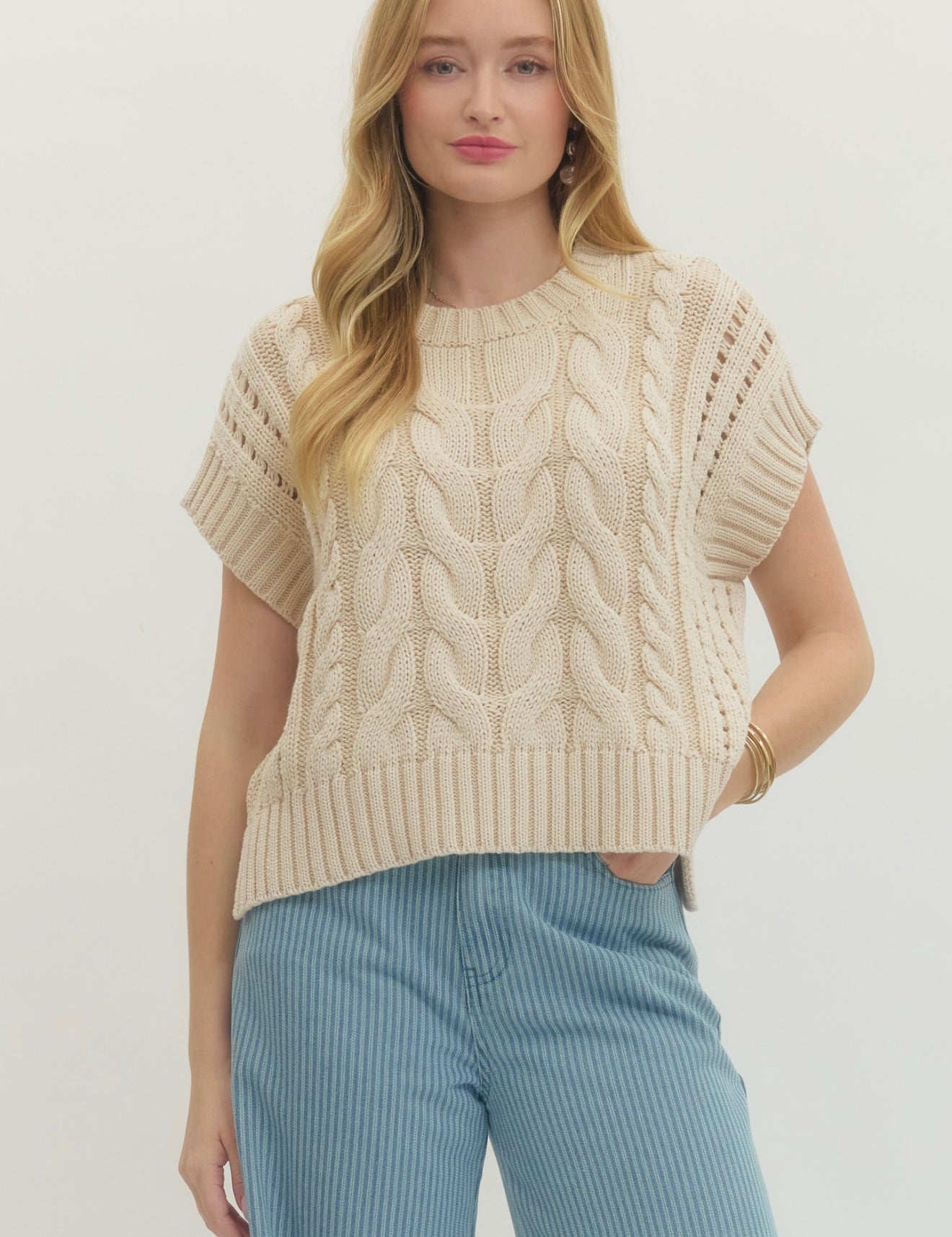 Cream Sweater Vest Top, a cream cable-knit sweater vest, worn front view