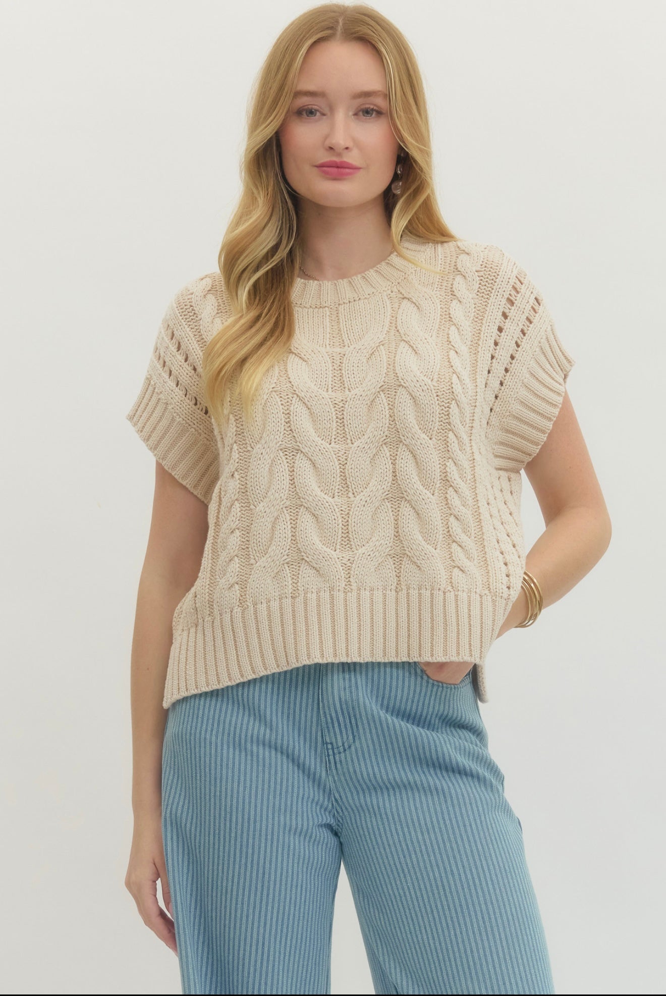 Cream Sweater Vest Top, a cream cable-knit sweater vest, worn front view