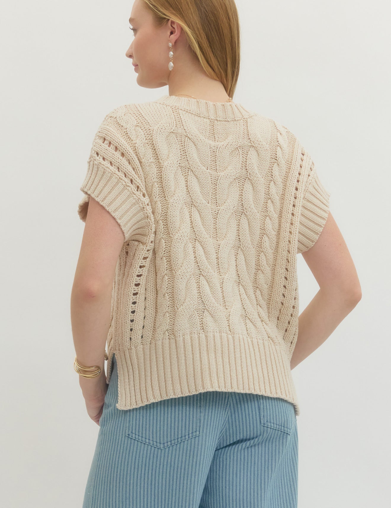 Back view of the Cream Sweater Vest Top, a cream cable-knit sweater vest – Lady & Tucker