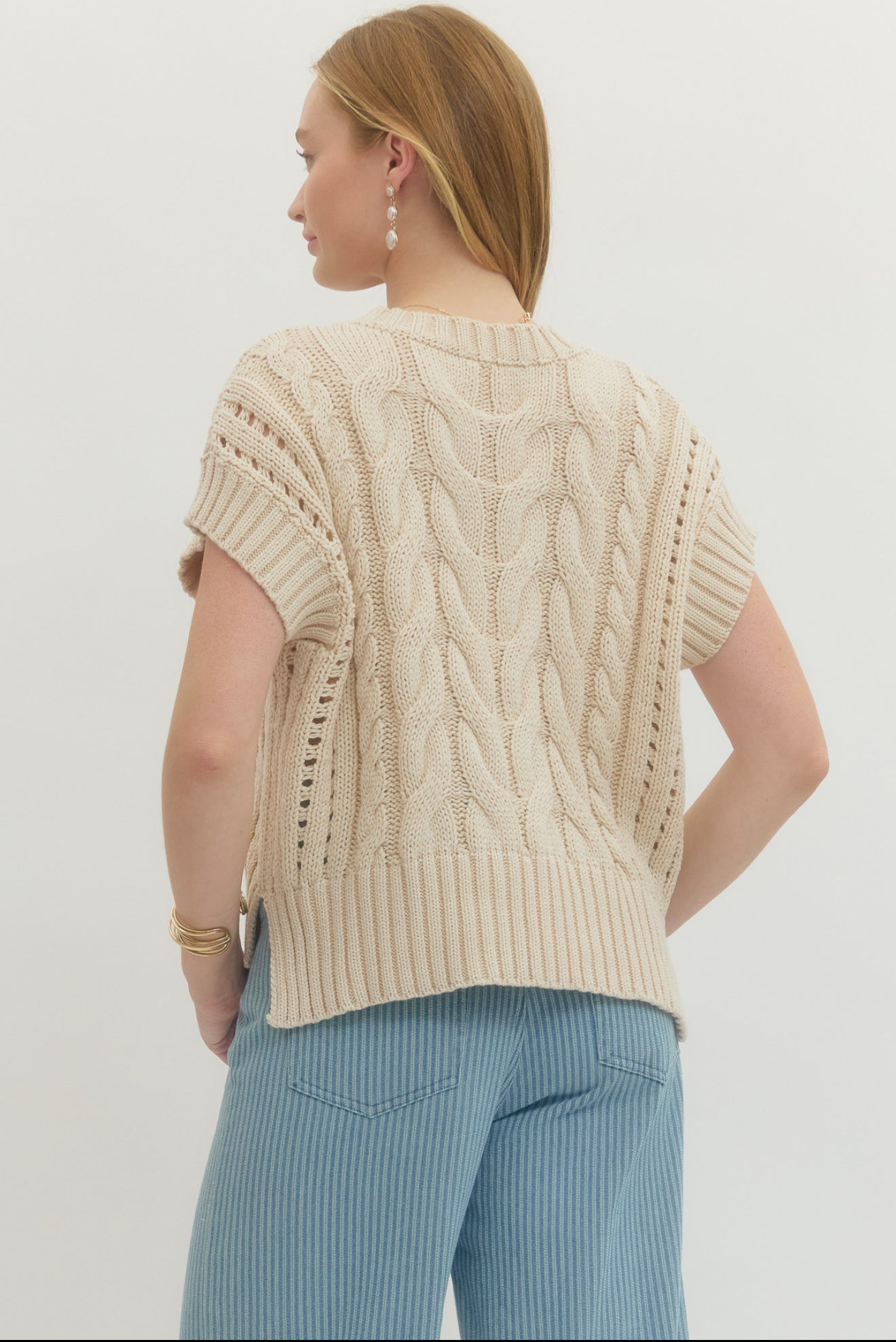 Back view of the Cream Sweater Vest Top, a cream cable-knit sweater vest – Lady & Tucker