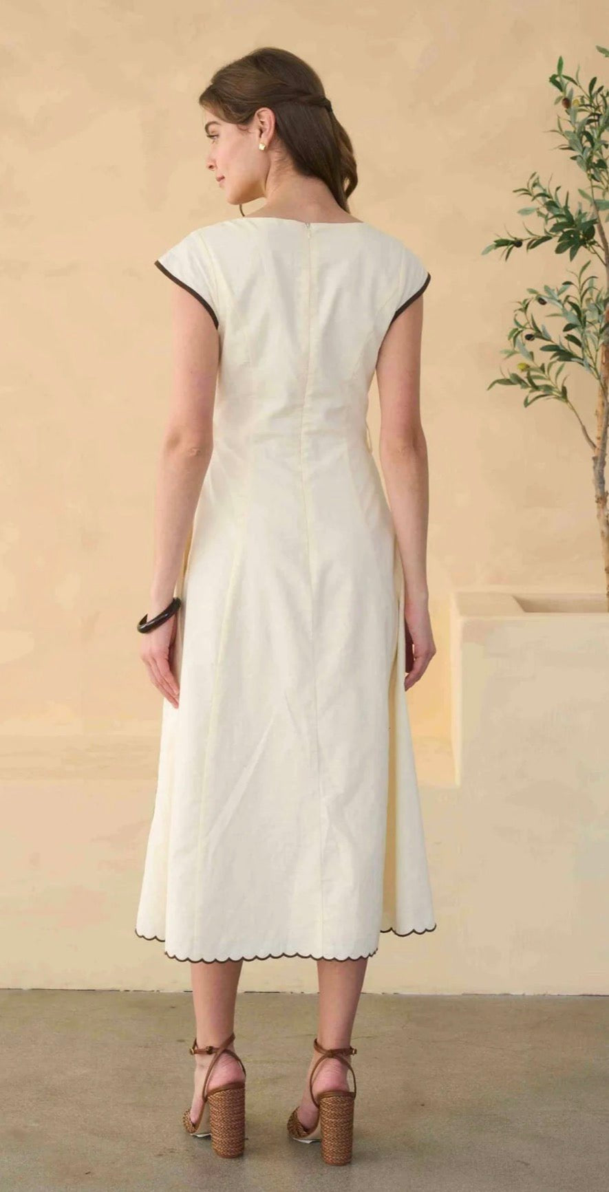 Back view of the Varenna Dress, an embroidered square-neck sleeveless midi