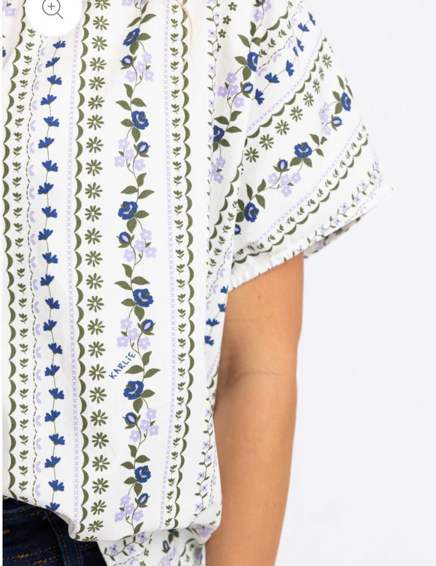 Back view of the French Floral Signature Top, a French-blue and lavender floral stripe blouse – Lady & Tucker