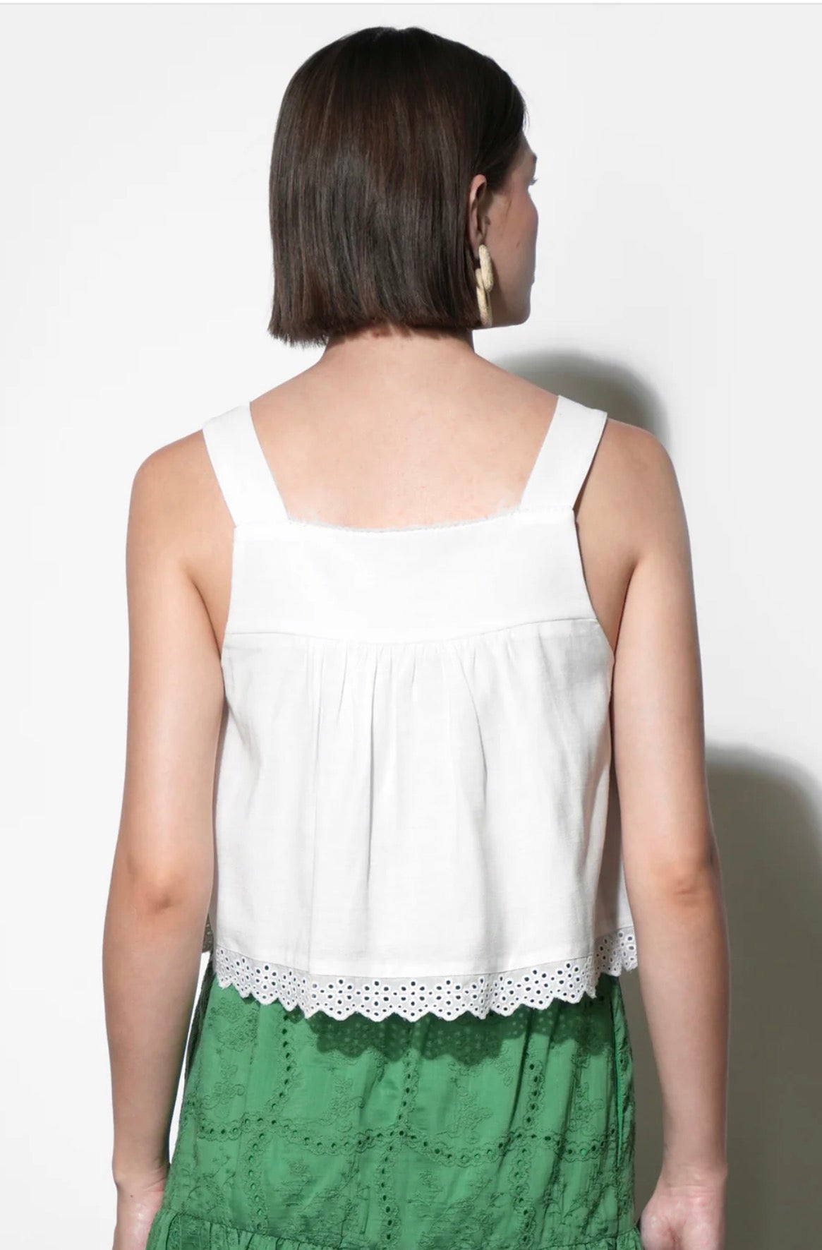 Close-up of the pintucks and scalloped eyelet hem on the Elani Eyelet Tank Top
