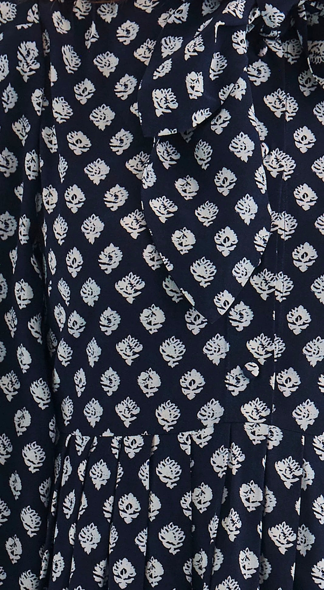 Close-up of the tie neckline and button cuffs on the Lila Dress