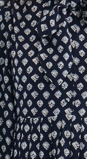 Close-up of the tie neckline and button cuffs on the Lila Dress