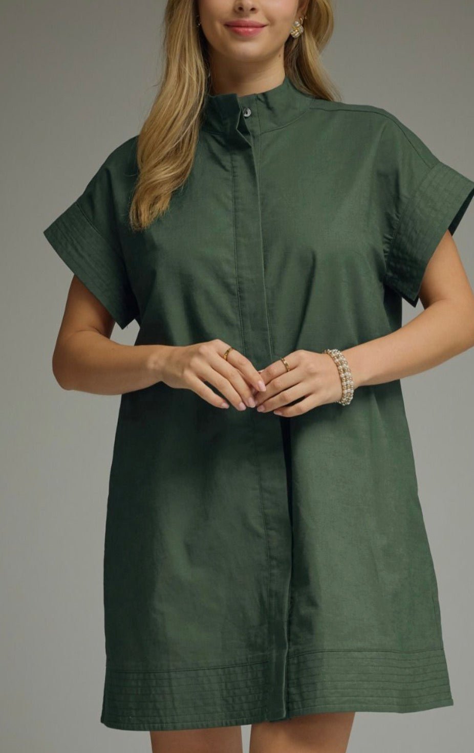 Greenday Dress, a hunter green shift dress with stand collar, worn front view