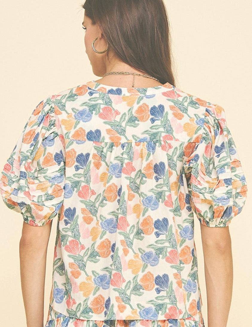 Back view of the Floral V-neck Top, an ivory floral print V-neck blouse – Lady & Tucker