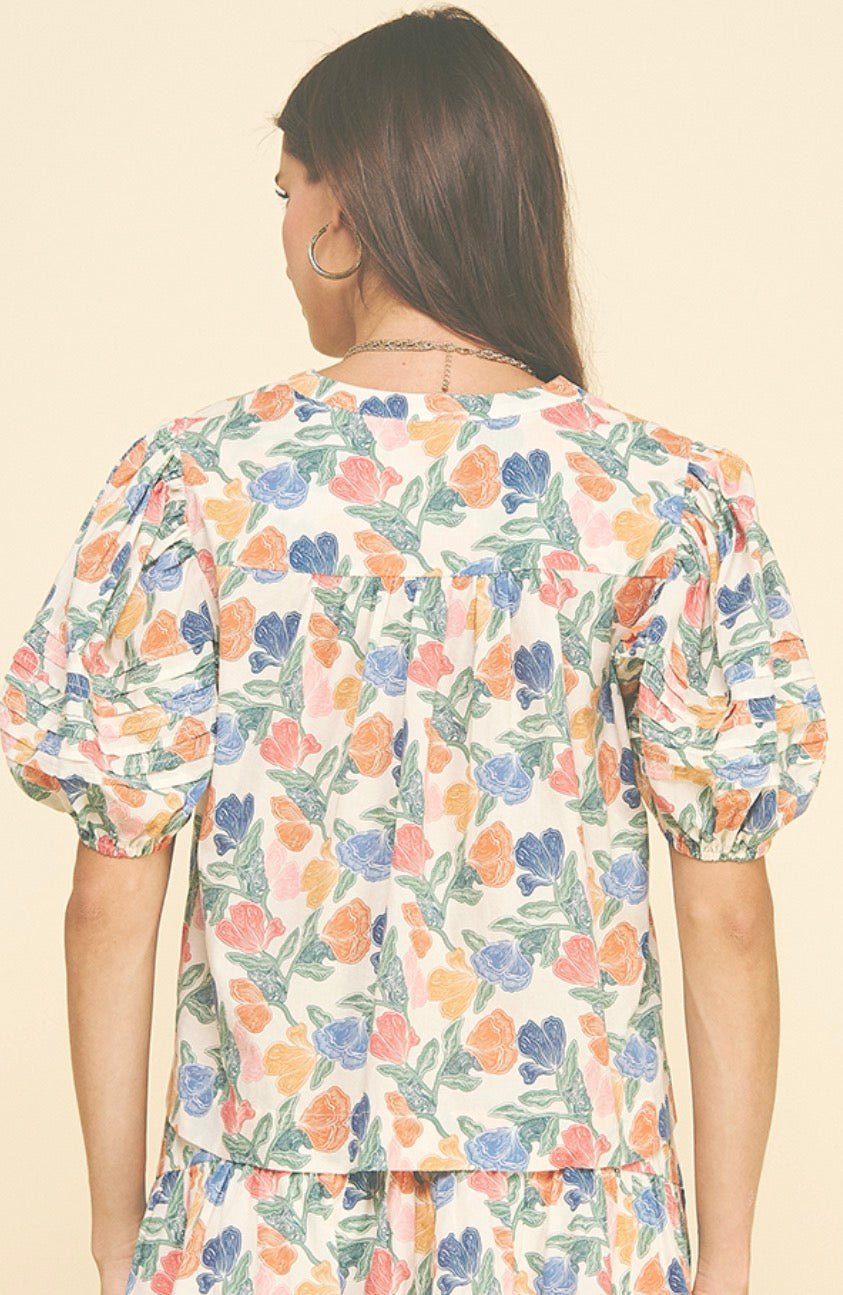 Back view of the Floral V-neck Top, an ivory floral print V-neck blouse – Lady & Tucker