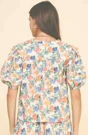 Back view of the Floral V-neck Top, an ivory floral print V-neck blouse – Lady & Tucker