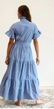 Close-up of the tiered skirt and stripe pattern on the Harbor Stripe Maxi Dress