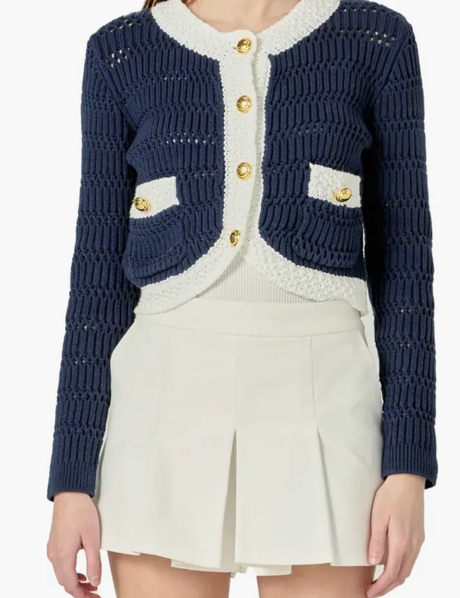 Navy Cropped Knit Sweater, a cropped navy cardigan with gold buttons, worn front view