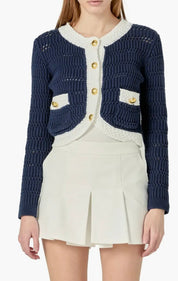 Navy Cropped Knit Sweater, a cropped navy cardigan with gold buttons, worn front view