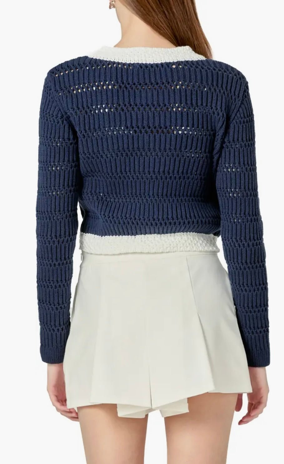 Back view of the Navy Cropped Knit Sweater, a cropped navy cardigan with gold buttons