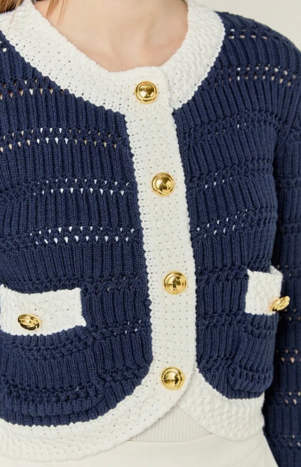 Close-up of the gold buttons and patterned stitching on the Navy Cropped Knit Sweater – Lady & Tucker