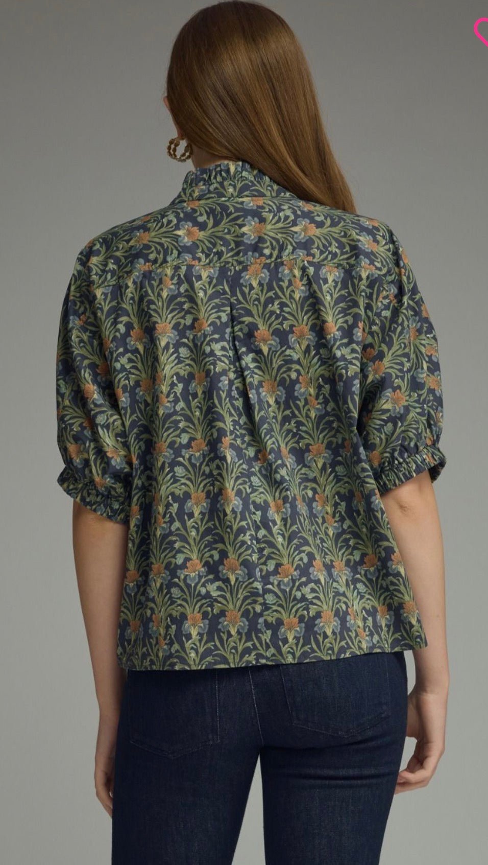 Back view of the Navy In Blooms Top, a navy floral ruffle-neck puff sleeve top