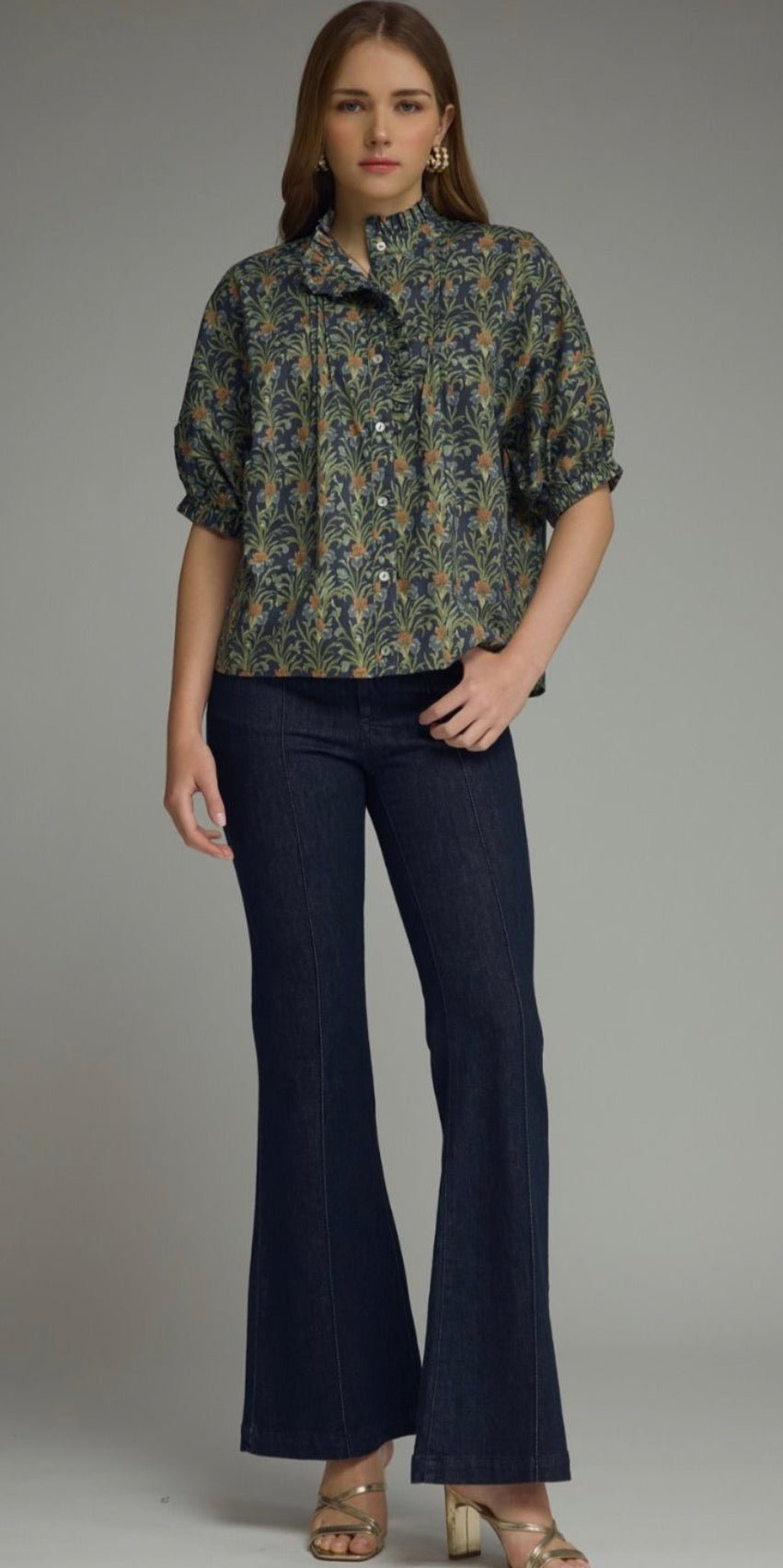 Close-up of the ruffled band collar and puff sleeves on the Navy In Blooms Top