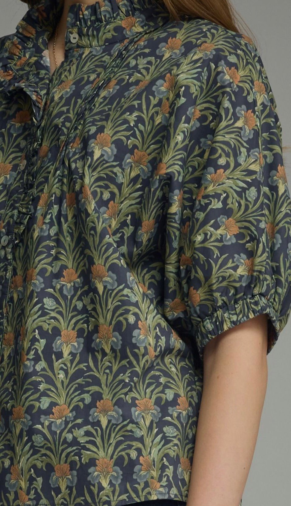 Navy In Blooms Top styled on model, a navy floral ruffle-neck puff sleeve top – Lady & Tucker