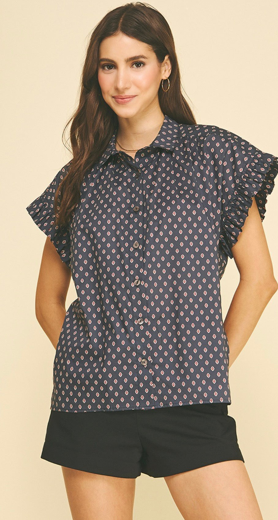 Ashford Top, a navy blouse with pink and ivory print, worn front view