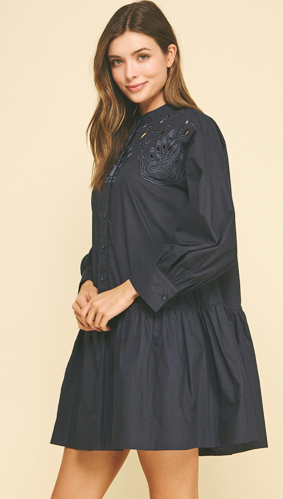 Close-up of the embroidered yoke and eyelet detail on the Embroidered Navy Mini Dress