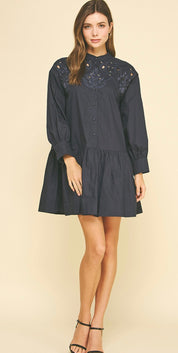 Side view of the Embroidered Navy Mini Dress showing the embroidered yoke and eyelet detail