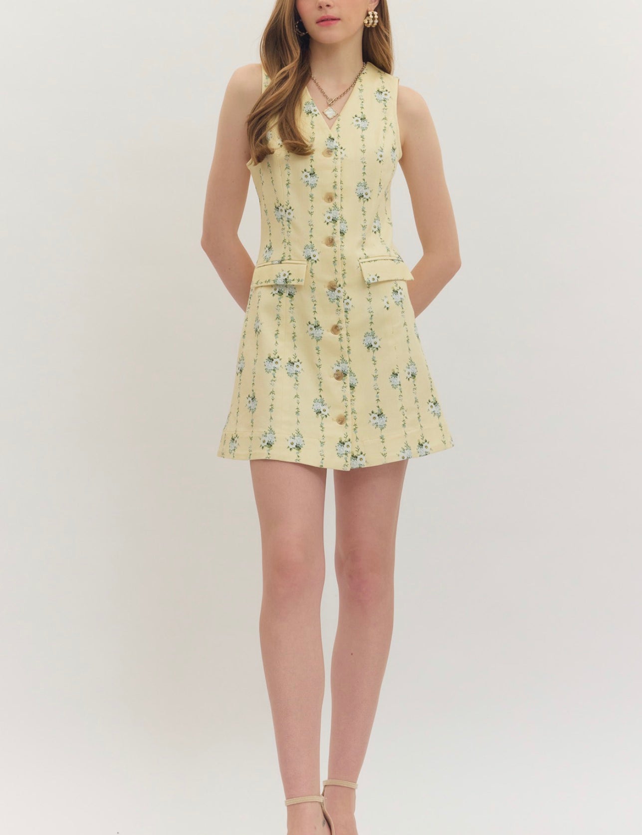 Lemon Yellow Floral Dress, a pastel yellow dress with blue floral sprigs, worn front view
