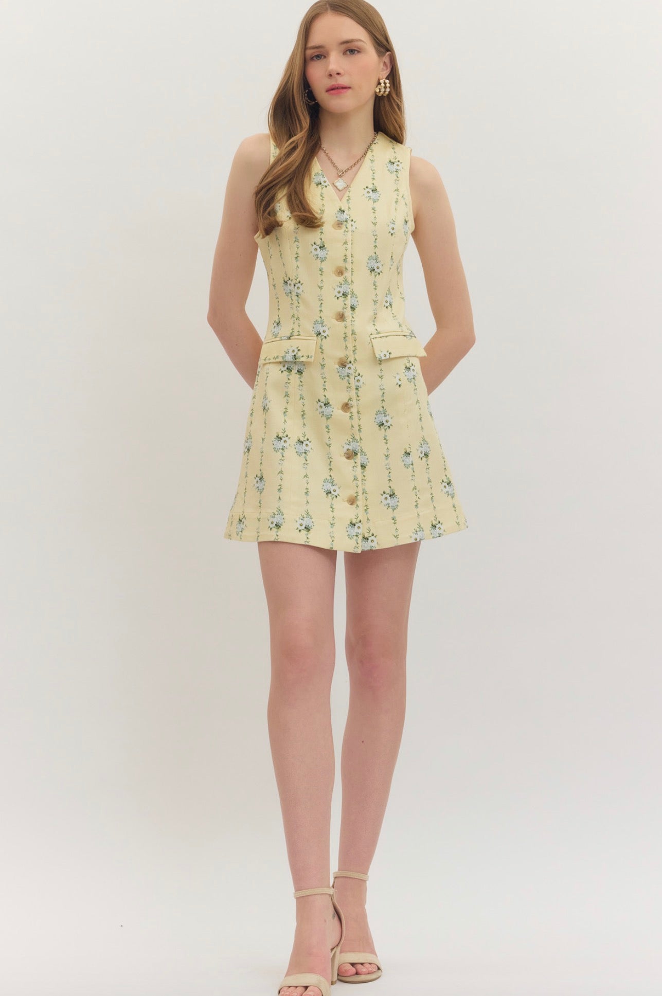 Lemon Yellow Floral Dress, a pastel yellow dress with blue floral sprigs, worn front view