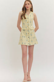 Lemon Yellow Floral Dress, a pastel yellow dress with blue floral sprigs, worn front view