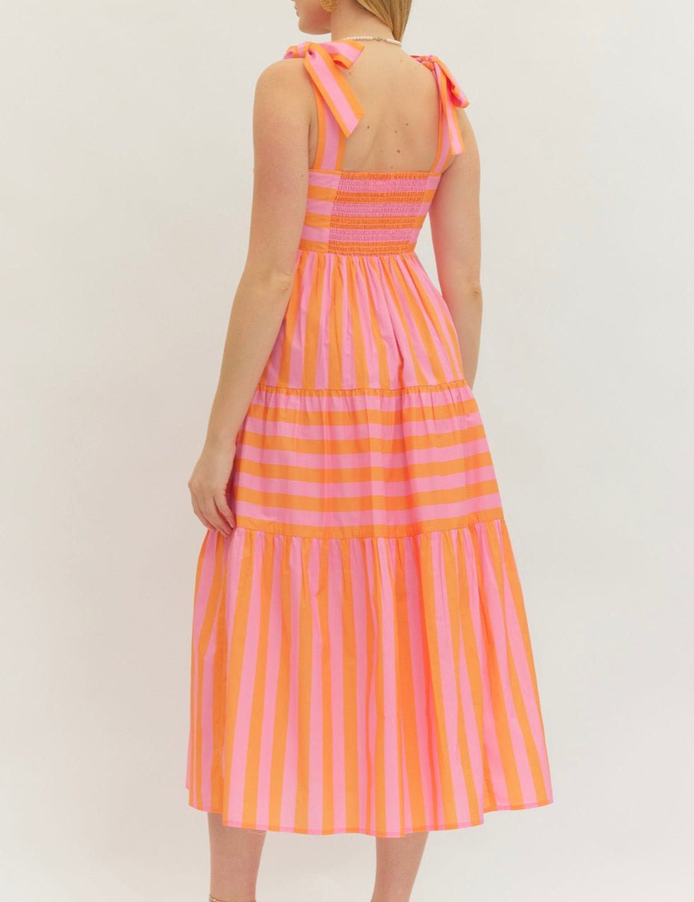 Back view of the Perfectly Striped Dress, a pink and orange horizontal stripe midi – Lady & Tucker