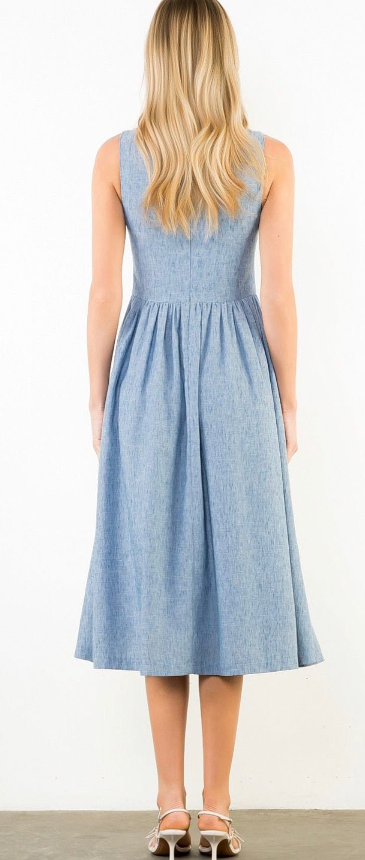 Back view of the Daily Denim Dress, a powder blue chambray bateau-neck midi