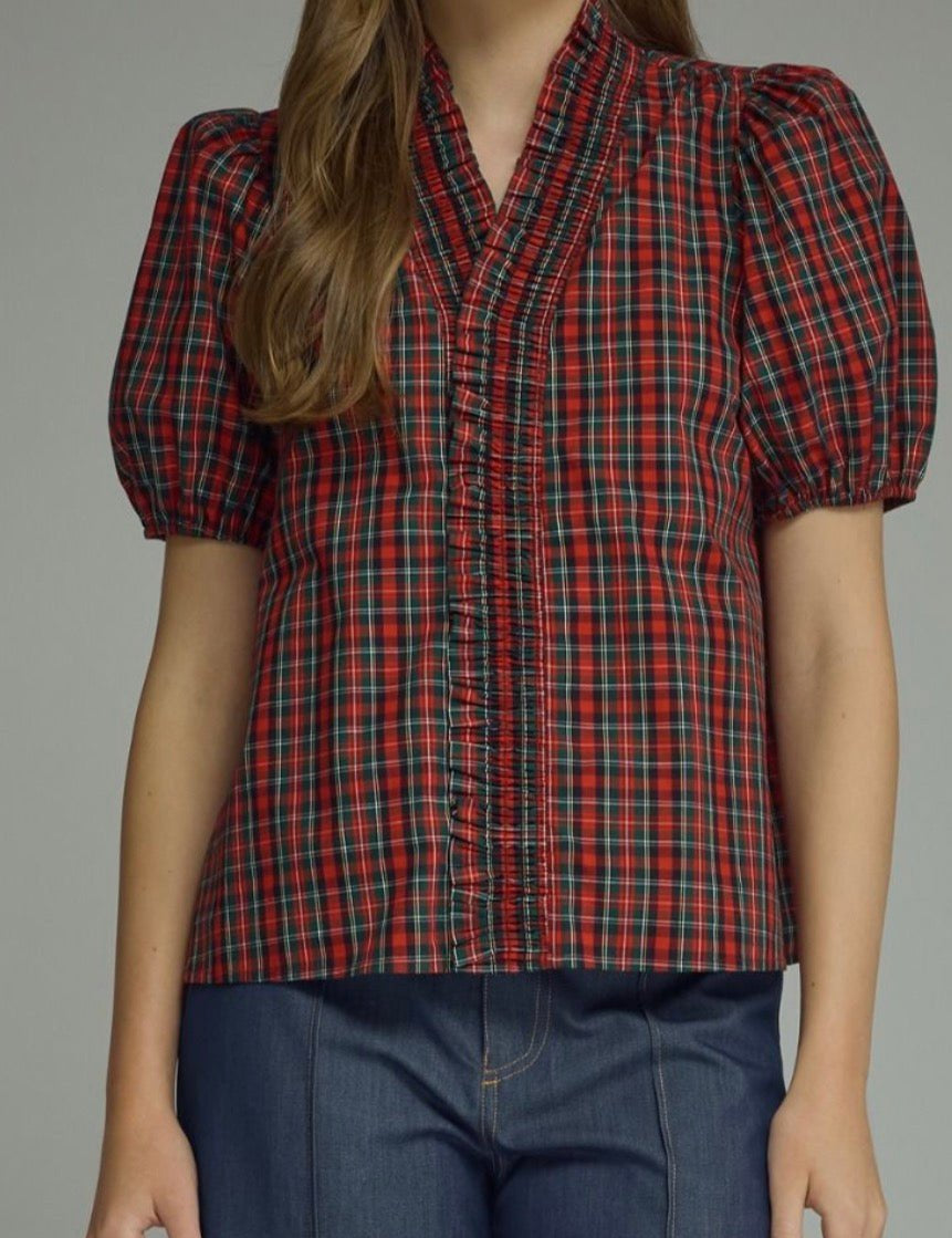Holiday Magic Top, a red and navy plaid ruffle blouse, worn front view