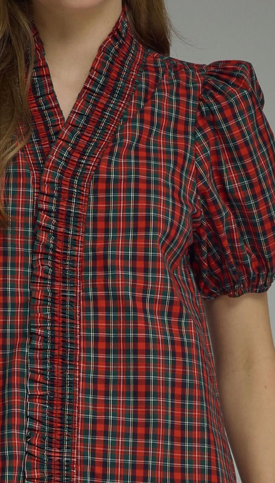 Holiday Magic Top styled on model, a red and navy plaid ruffle blouse