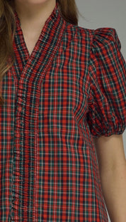 Holiday Magic Top styled on model, a red and navy plaid ruffle blouse