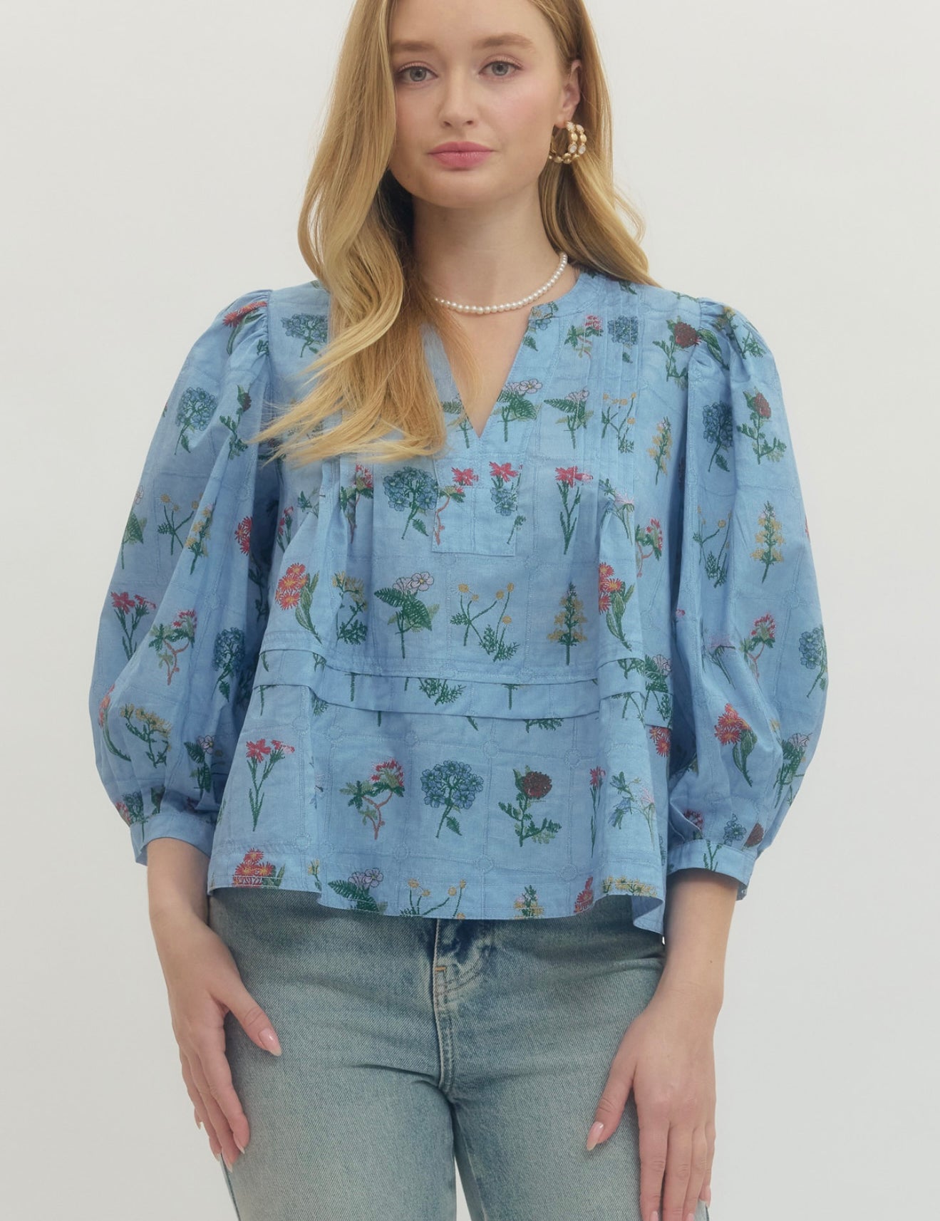 Chambray Floral Top, a soft blue floral empire waist blouse, worn front view